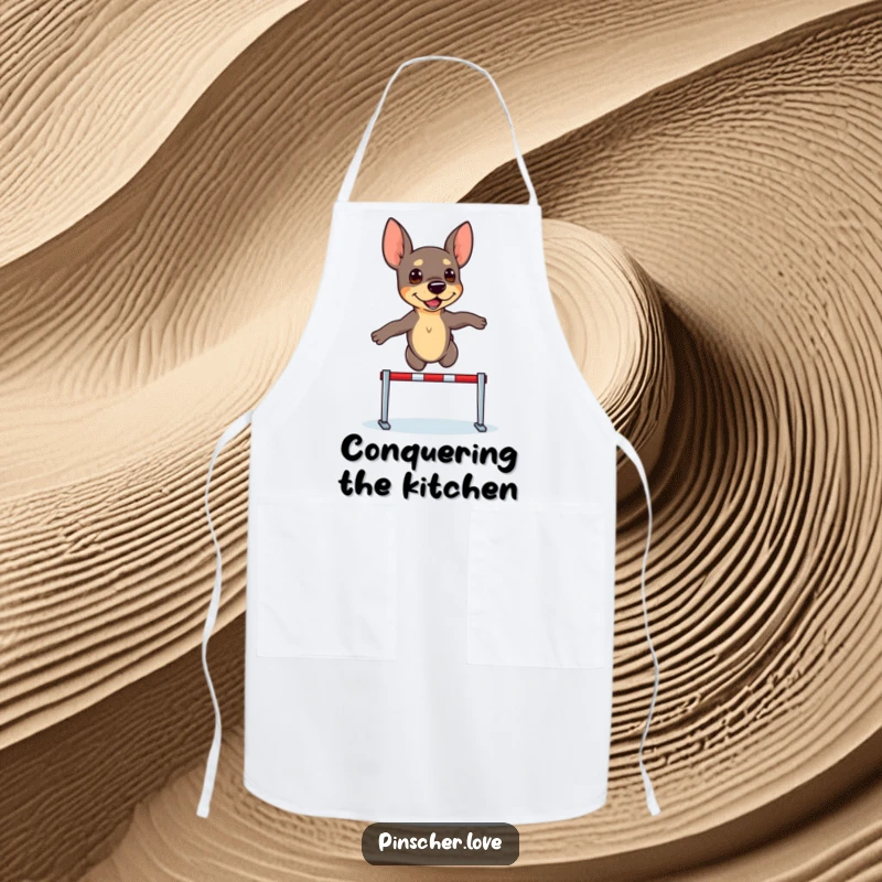 Funny Pinscher Apron: A determined pinscher dog leaps over a tiny hurdle, ready for kitchen challenges.