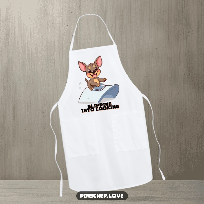 Funny apron featuring a Pinscher dog sliding down a ramp with glee, great for cooking and dog humor lovers, excellent funny gift.