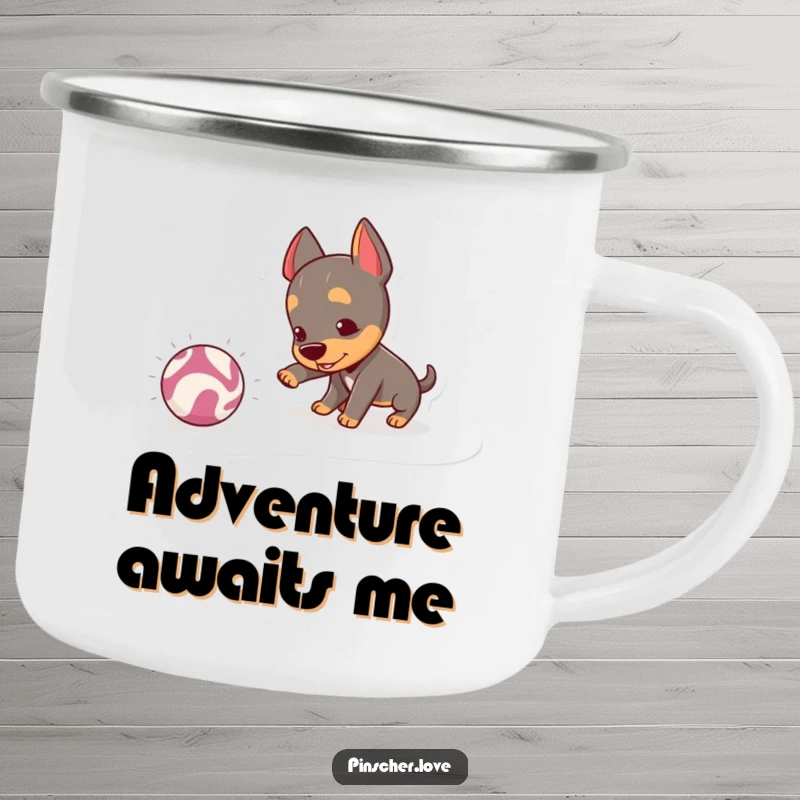 Funny Pinscher Camping Mug: A mischievous pinscher playfully nudges a crinkly ball, perfect for outdoor enjoyment and humorous moments.