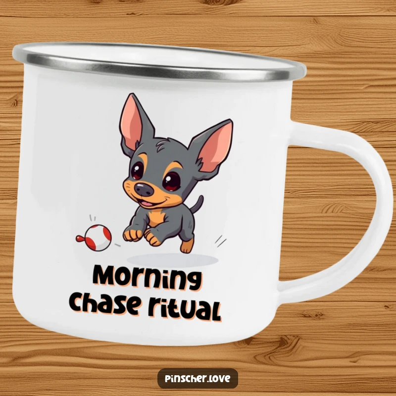 Funny pinscher camping mug depicting an energetic pinscher dog chasing a small, fleeing toy, perfect for outdoor fun.