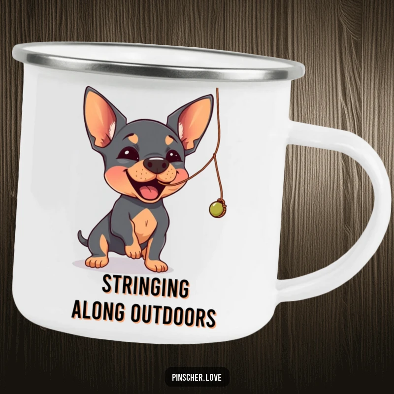 Funny Pinscher camping mug showing a Pinscher dog joyfully batting at a dangling, wobbly string.