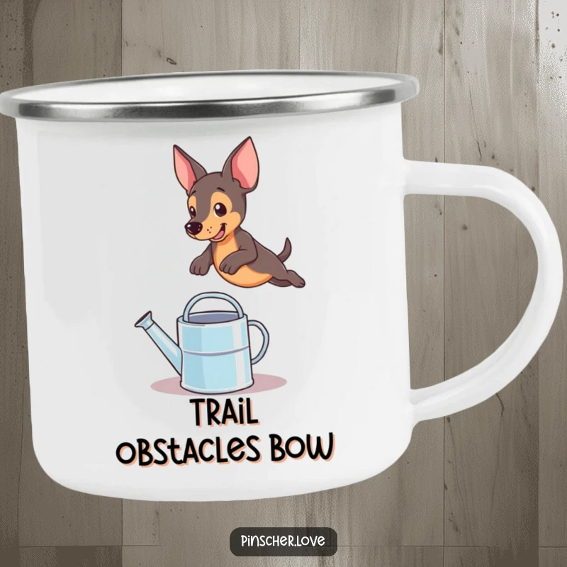 Funny pinscher dog leaping over a watering can on a sturdy enamel camping mug, perfect for outdoor humor
