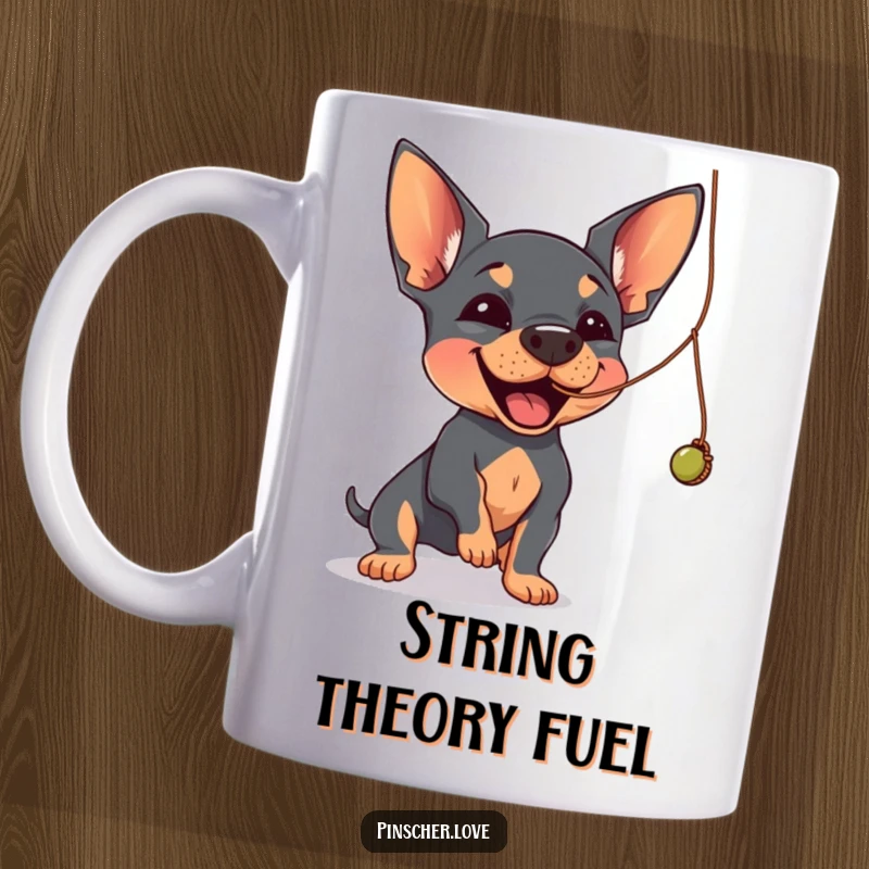 Funny Pinscher mug showing a Pinscher dog joyfully batting at a dangling, wobbly string with its paw.