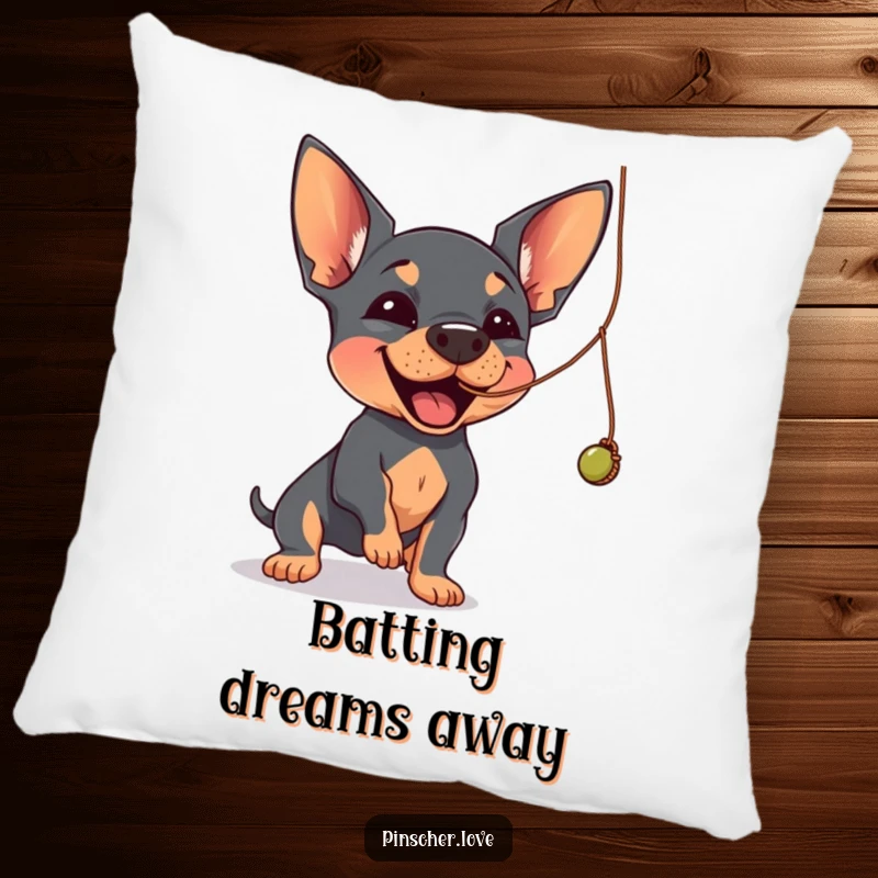 Funny Pinscher pillow featuring a Pinscher dog joyfully batting at a dangling, wobbly string.