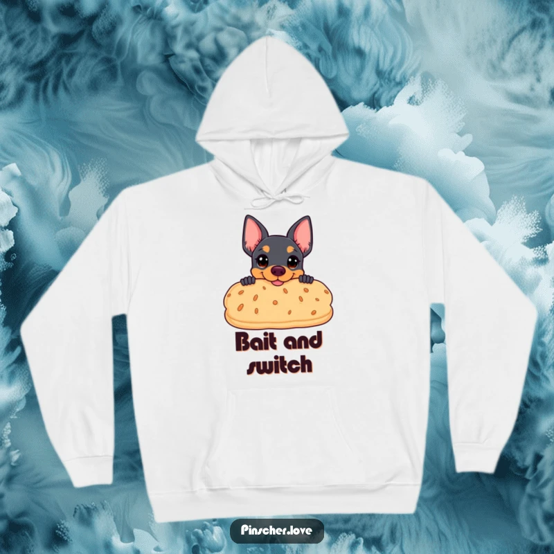 Funny hoodie depicting a pinscher coyly peeking from behind a giant, smiling biscuit, perfect for snack enthusiasts.