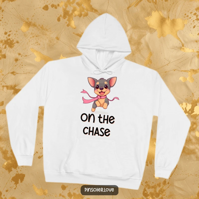 Funny pinscher puppy hoodie, illustrating a small dog madly chasing a fluttering ribbon. Cozy apparel for dog enthusiasts.