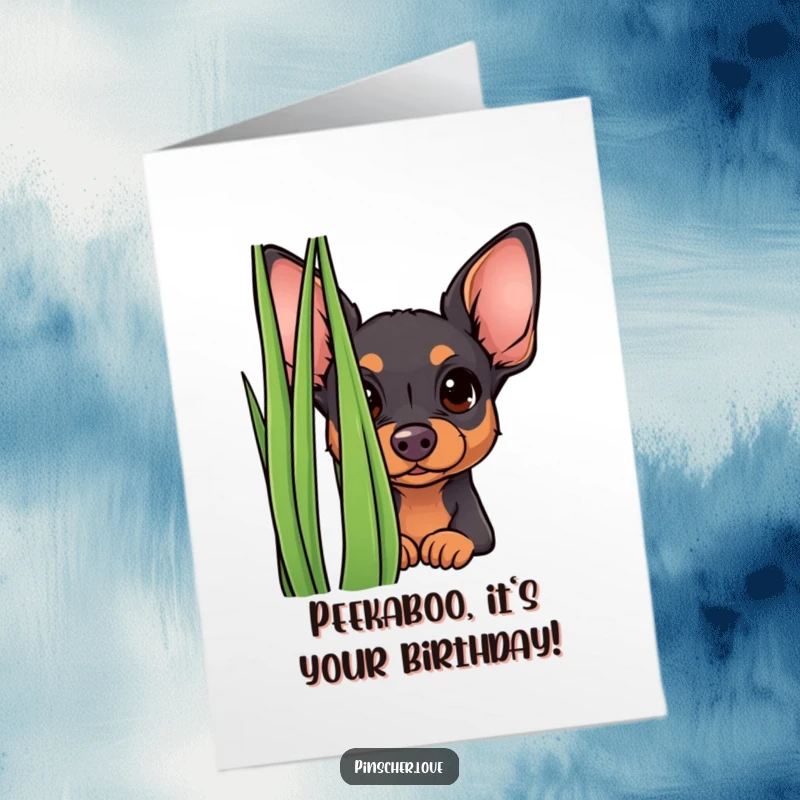 Funny Free Printable Birthday Card: Adorable pinscher puppy with wide, curious eyes peeking from behind a tall green blade of grass.