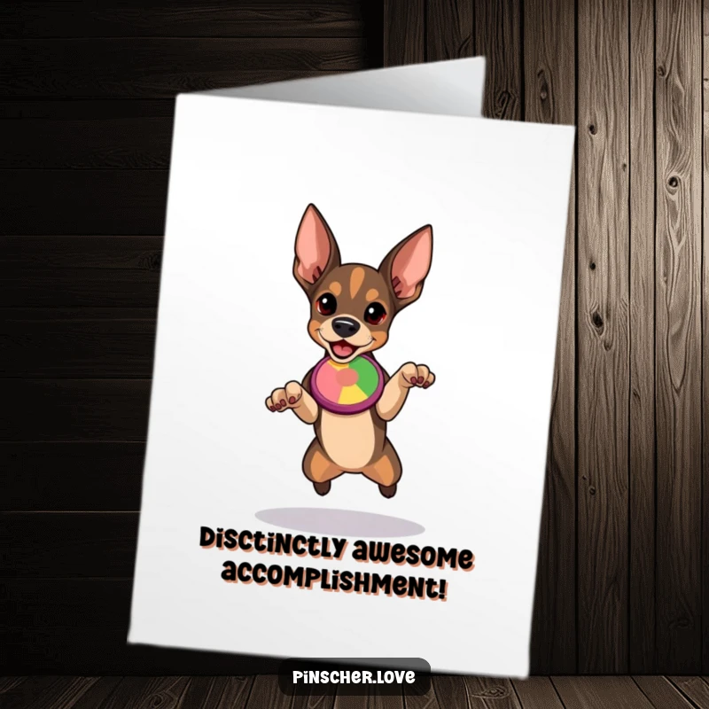 Free Printable Congratulations Card, Pinscher dog poised to leap, eyes focused on a colorful flying disc, ready for success.