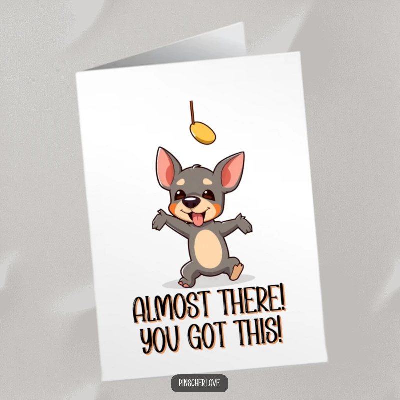 Funny Free Printable Congratulations Card: A pinscher comically falls reaching for a toy, capturing a moment of playful struggle.