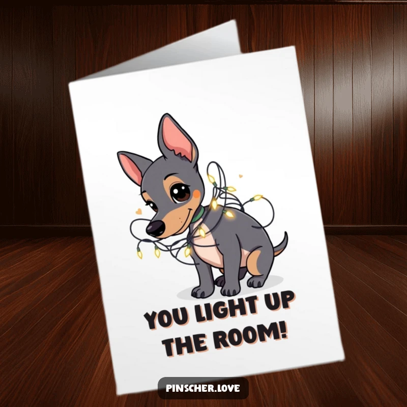 Funny Free Printable Congratulations Card: A happy Pinscher playfully tangled amongst twinkling fairy lights, celebrating joyously.