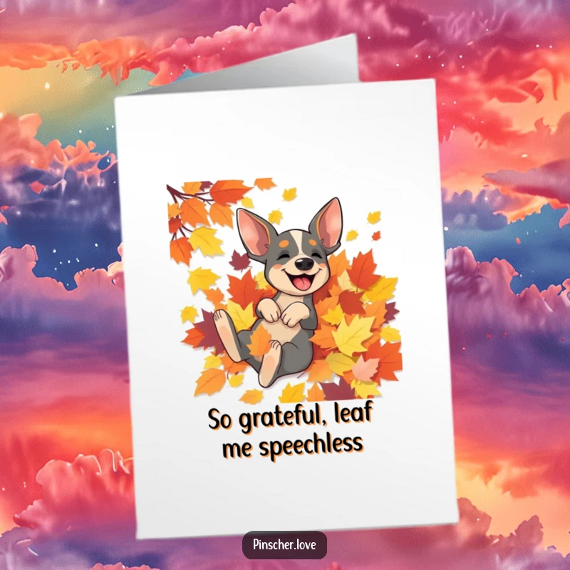 Funny free printable thank you card of a happy pinscher dog rolling with delight in a big pile of colorful autumn leaves.