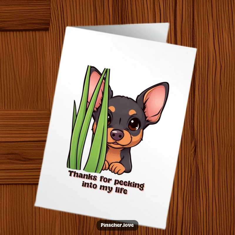 Funny Free Printable Thank You Card: A curious pinscher puppy peeking from behind a tall blade of grass, conveying thanks.