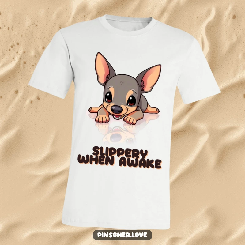 Funny Pinscher t-shirt depicting a Pinscher dog mid-slip, arms and legs flailing comically on a shiny, slippery surface.