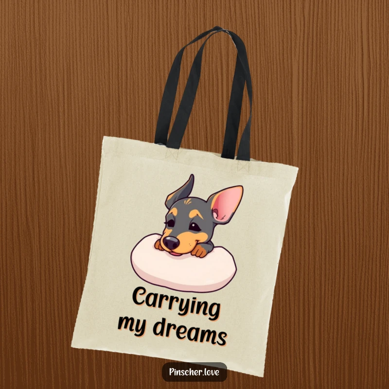 Funny tote bag featuring a Pinscher resting its chin on a soft cushion, sighing contently.