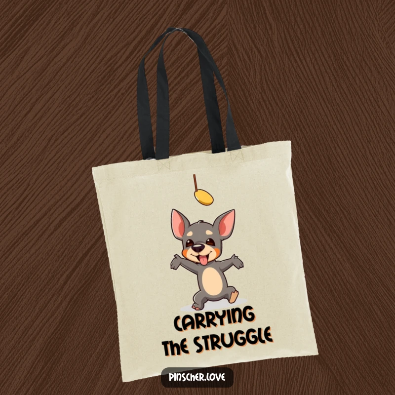 Funny Pinscher Tote Bag: A pinscher comically falls reaching for a toy, showcasing a hilarious, energetic pursuit for a great gift.