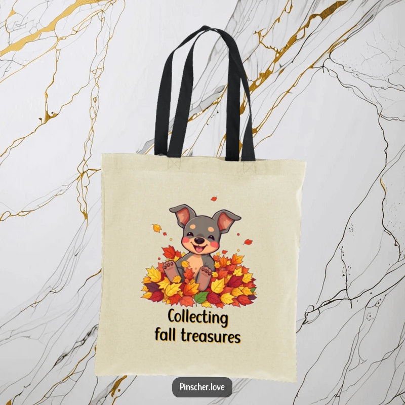 Funny tote bag with a pinscher character joyfully rolling in a pile of colorful autumn leaves.