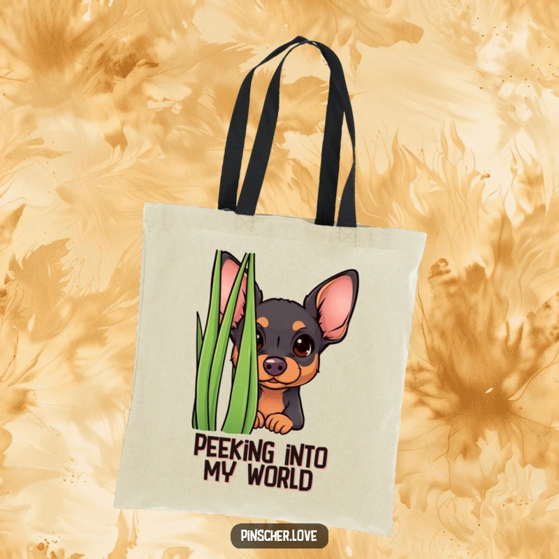 Funny curious pinscher tote bag, picturing a small dog peeking from behind grass with a curious gaze. Humorous and practical.