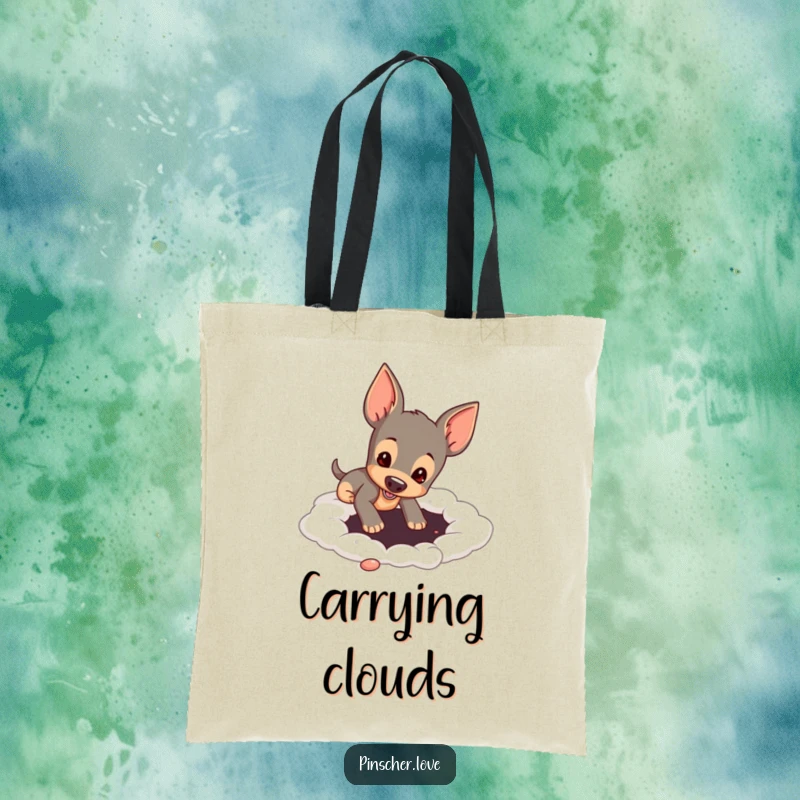 Funny pinscher dog digging a hole in a soft, cloud-like surface, featured on a tote bag for humorous practicality