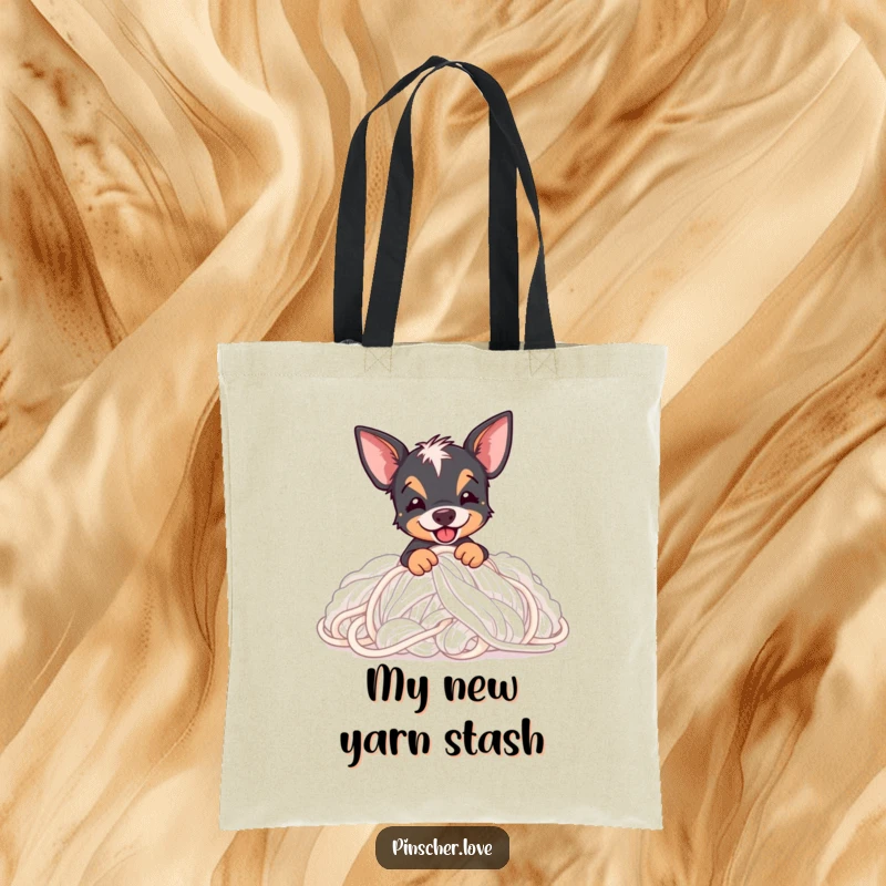 Funny Pinscher tote bag with a Pinscher dog gleefully digging into a massive pile of soft, fluffy yarn.