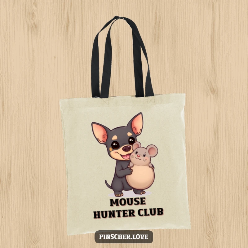 Funny Pinscher tote bag illustrating a delighted dog proudly posing with a massive squeaky toy mouse, a true symbol of joy.